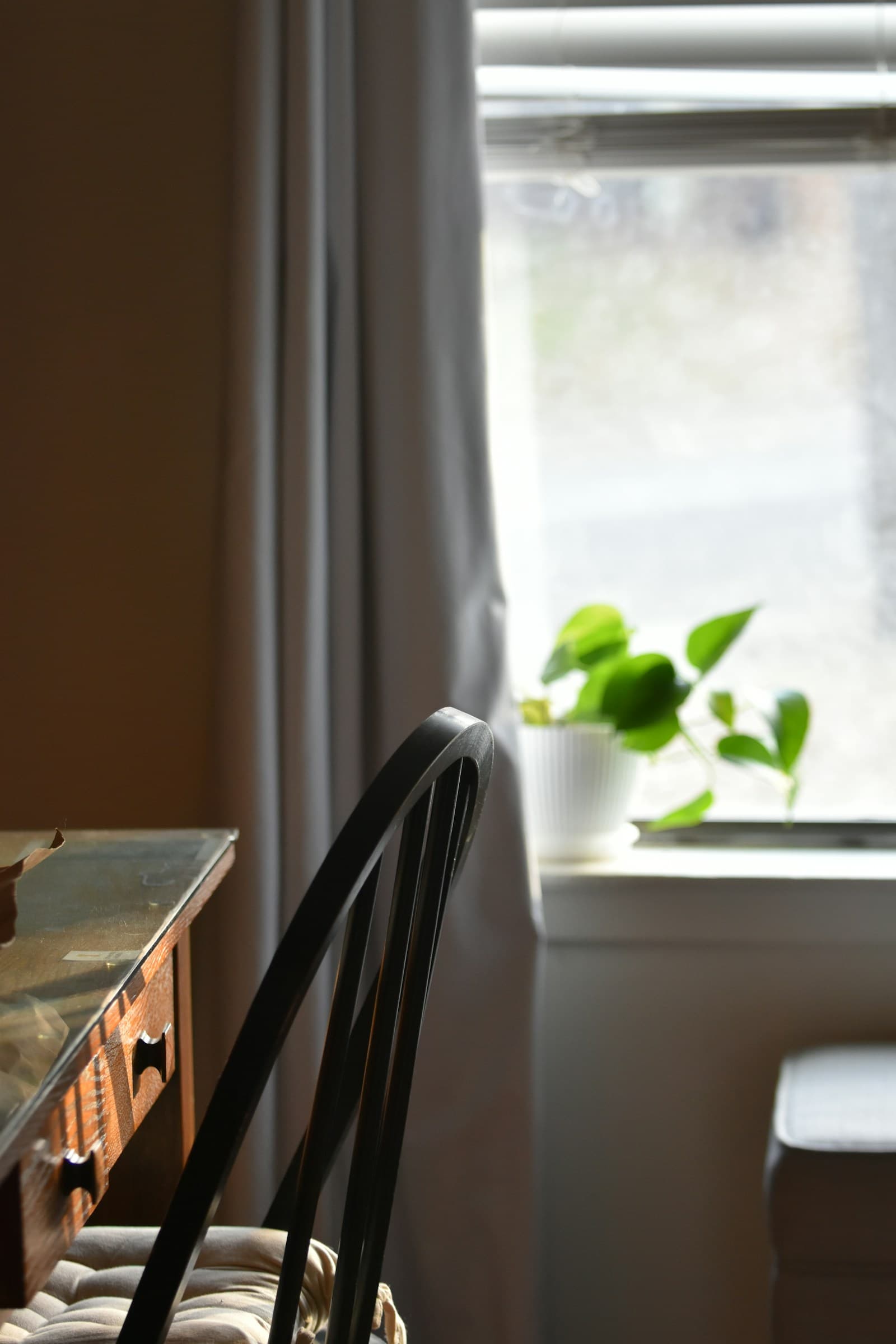 Two people sitting across a kitchen table with paperwork between them